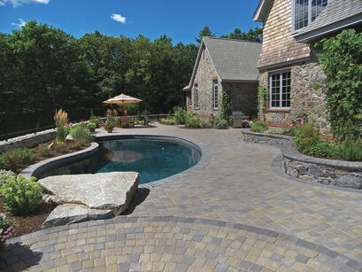 Ideal Concrete Block catalog image of pool deck and patio space with retaining wall